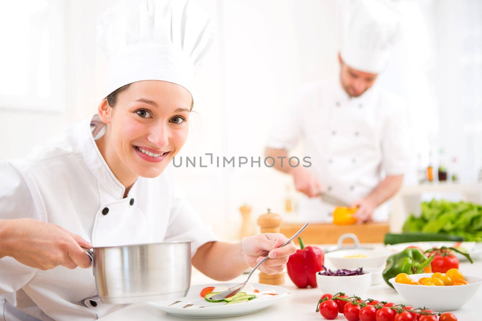 View of a Young attractive professional chef cooking in his kitchen