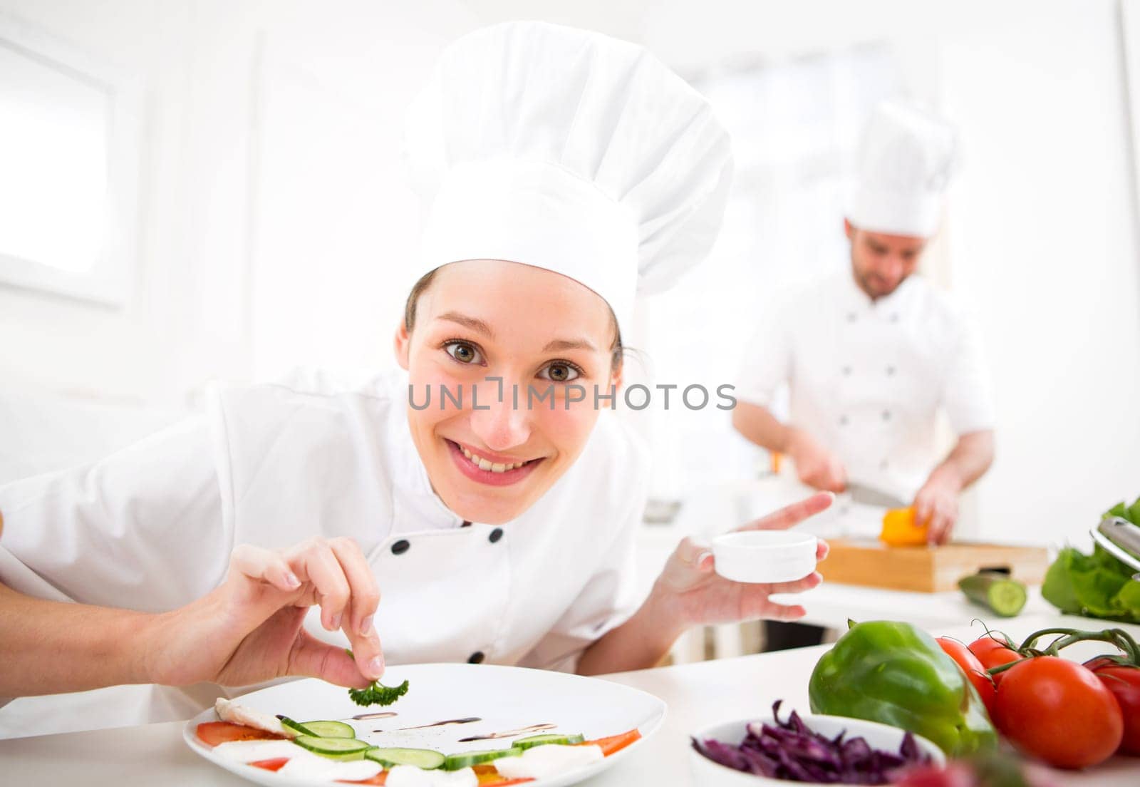 View of a Young attractive professional chef cooking in his kitchen