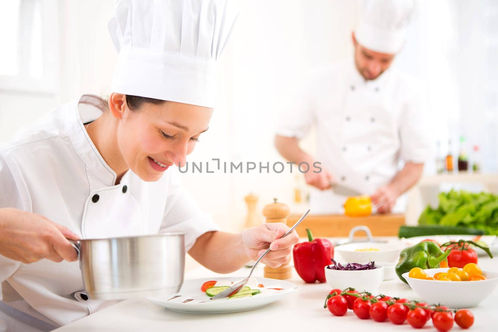 View of a Young attractive professional chef cooking in his kitchen