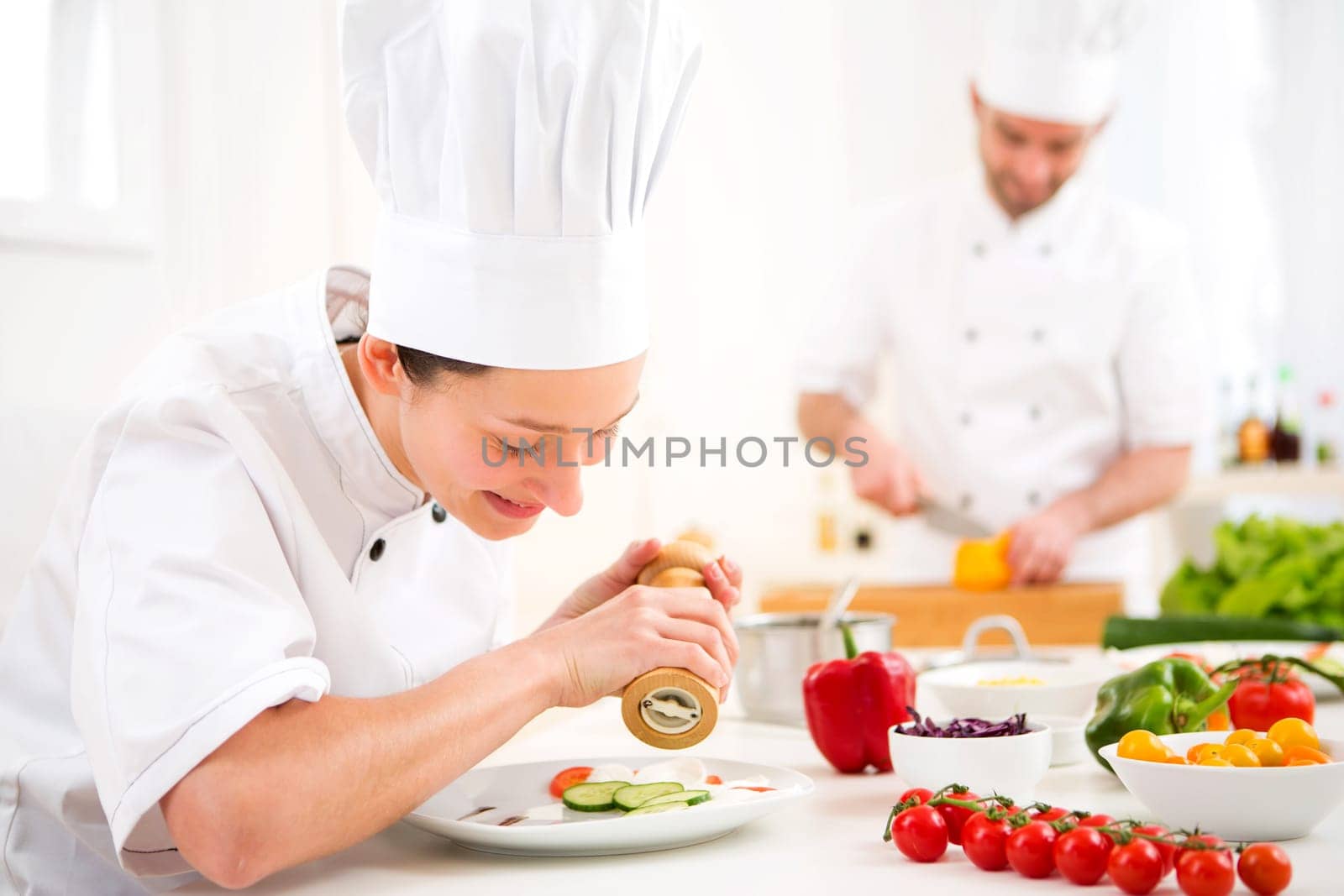 View of a Young attractive professional chef cooking in his kitchen