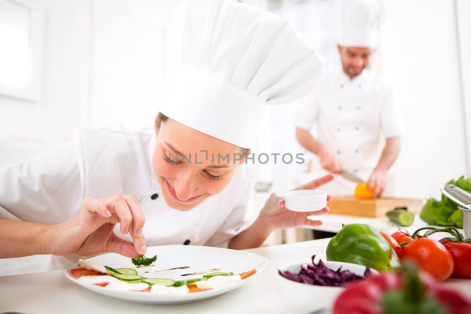 View of a Young attractive professional chef cooking in his kitchen
