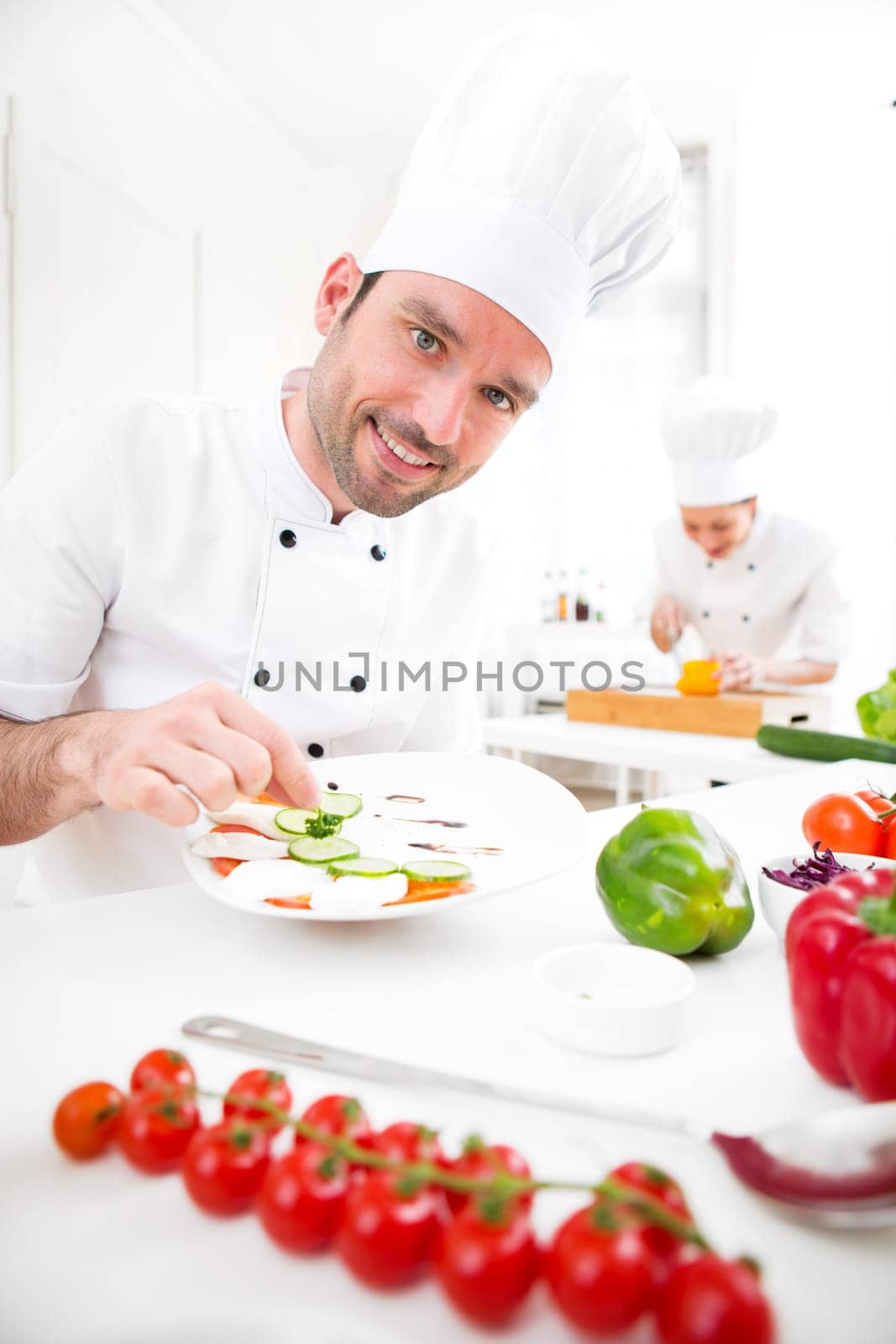 View of a Young attractive professional chef cooking in his kitchen