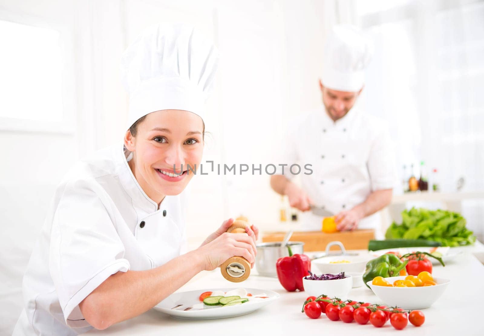 View of a Young attractive professional chef cooking in his kitchen