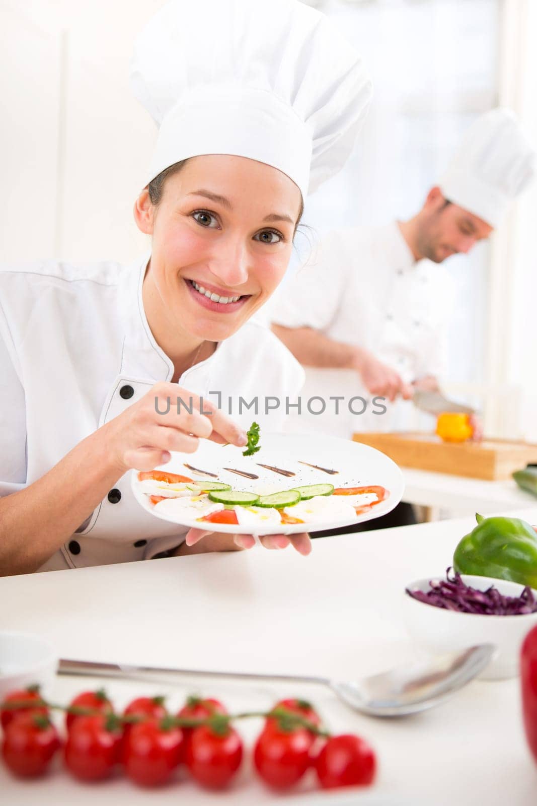 View of a Young attractive professional chef cooking in his kitchen