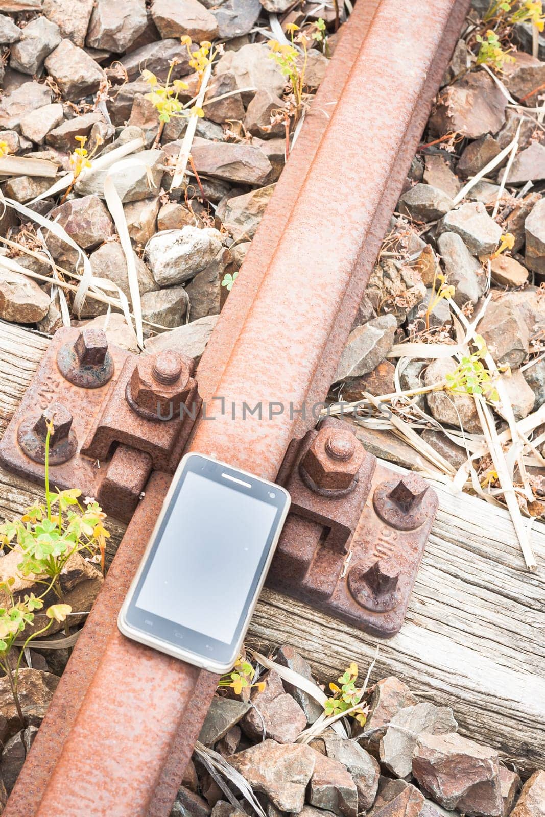 Travel on the tracks of the technology. Smartphone on rail like a metaphor.