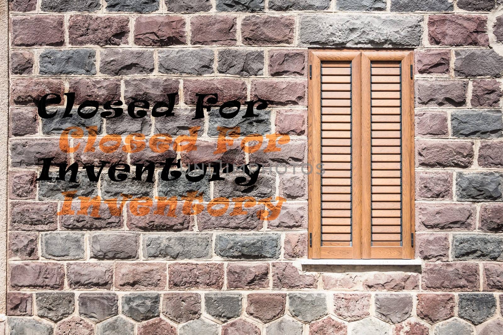 Window on the wall of basalt with written "Closed For Inventory"""