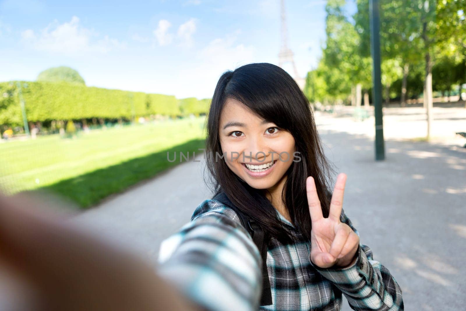 View of a Young attractive asian tourist in Paris taking selfie