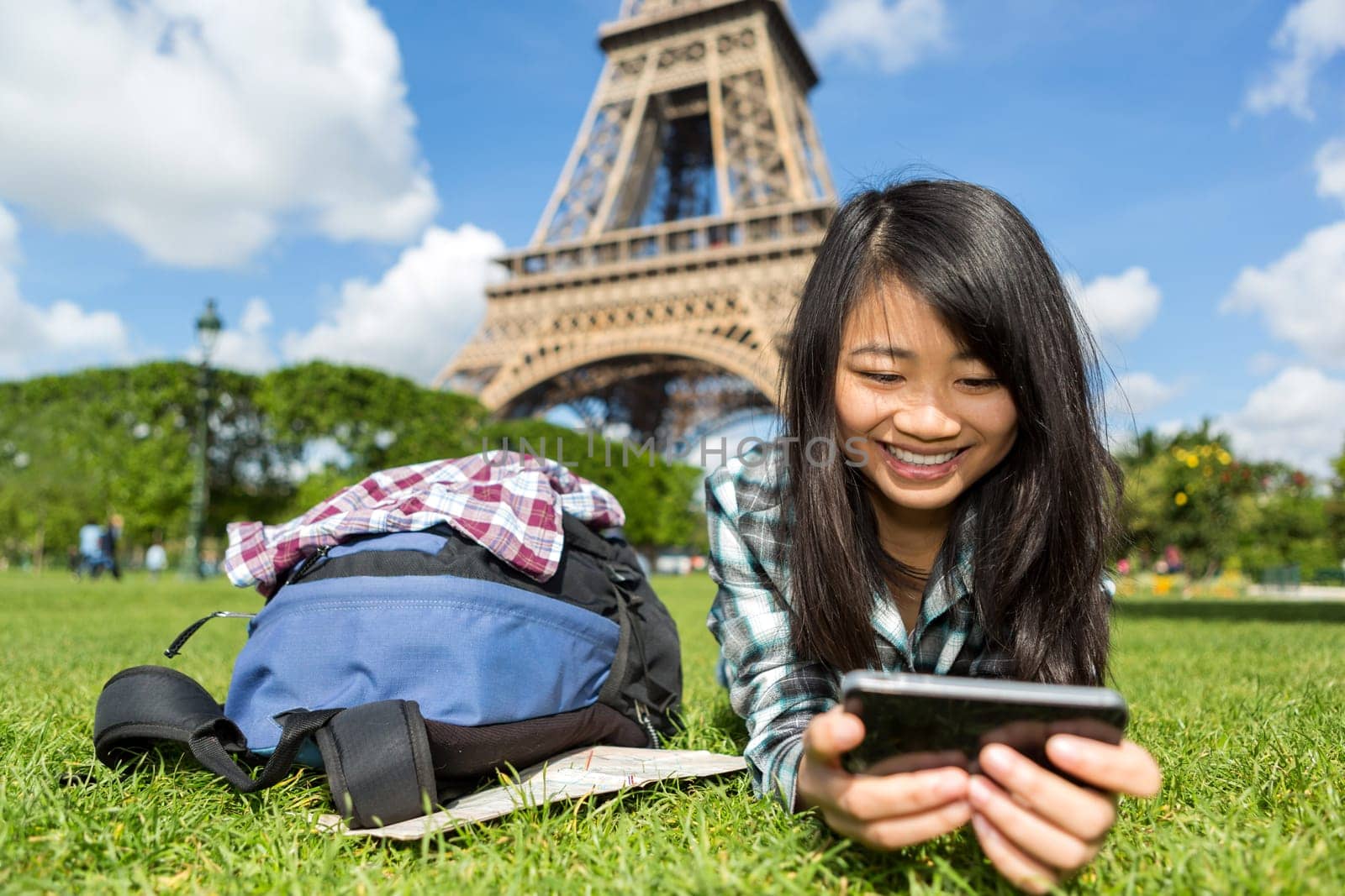 View of a Young attractive asian tourist smartphone tablet in Paris