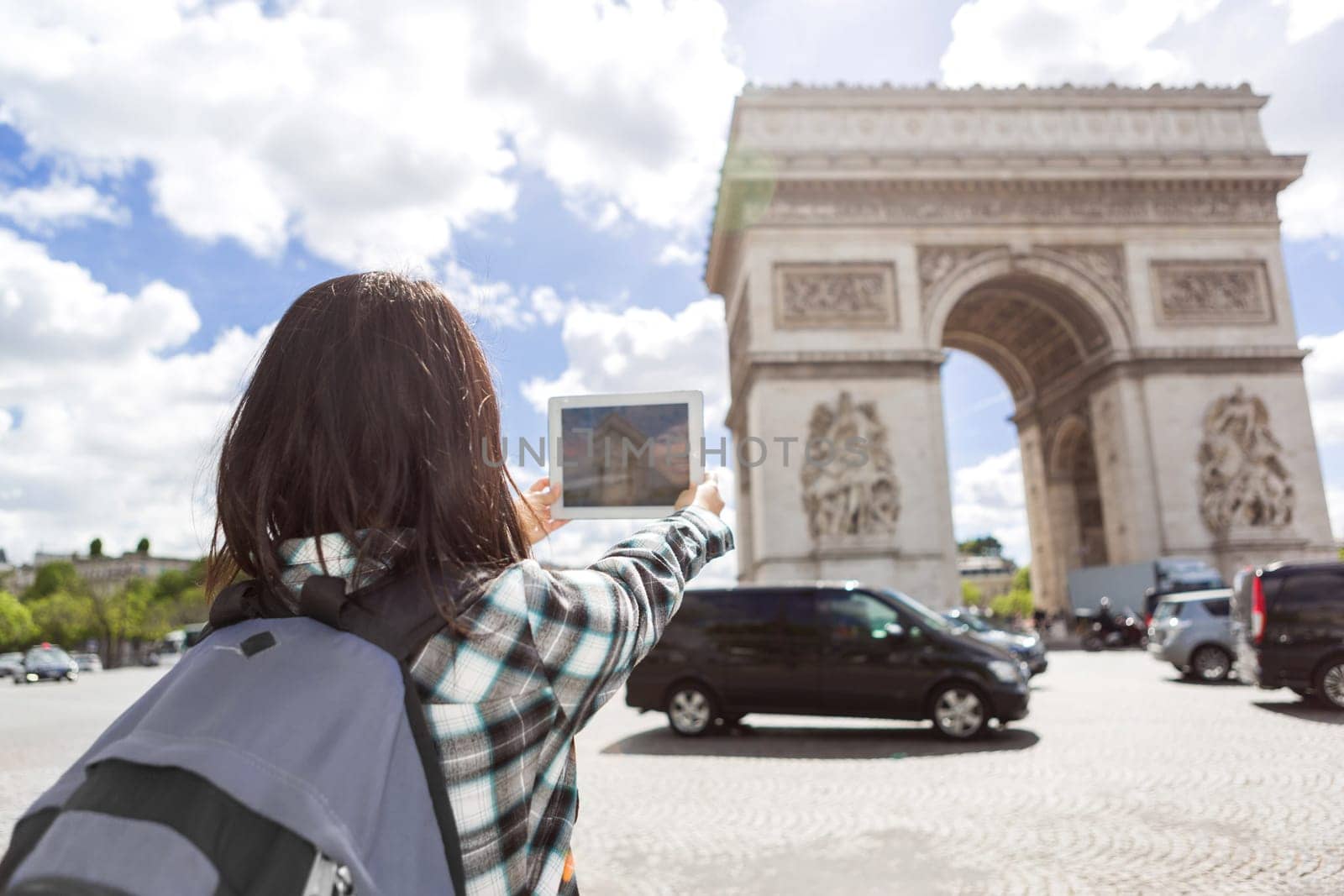 View of a Young attractive asian tourist taking pictures in Paris