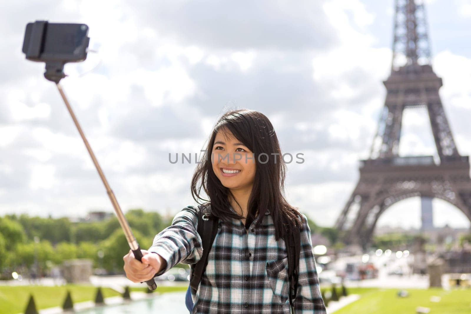 View of a Young attractive asian tourist in Paris taking selfie