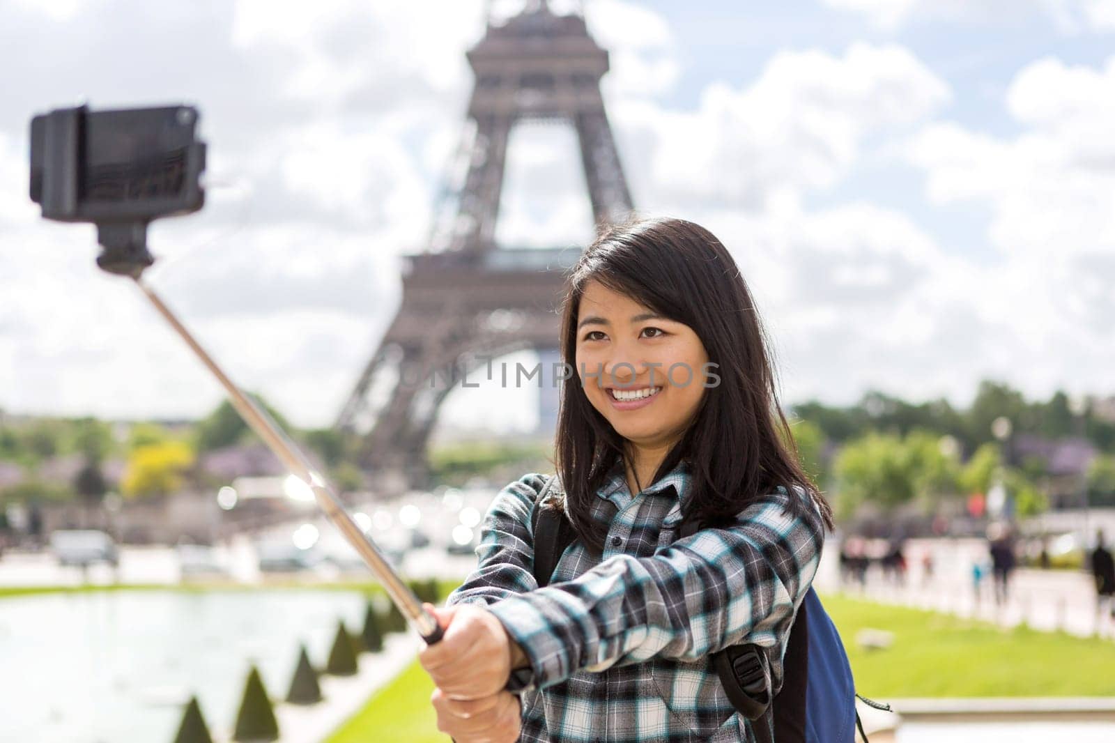View of a Young attractive asian tourist in Paris taking selfie