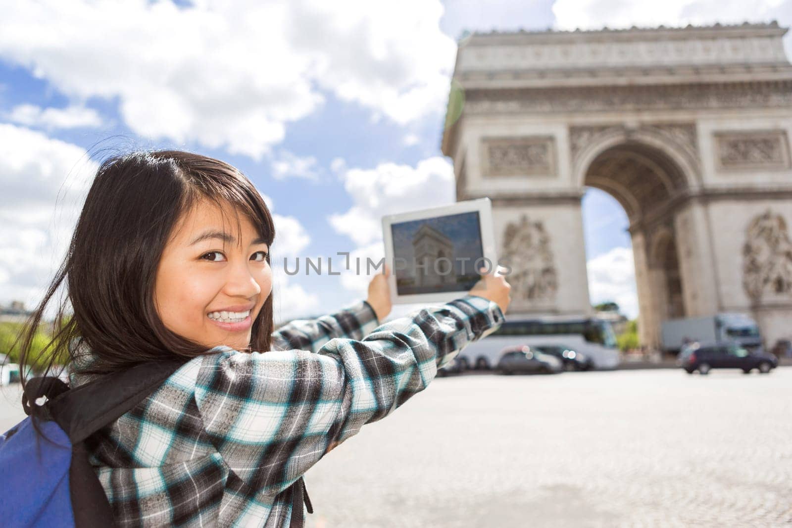 View of a Young attractive asian tourist taking pictures in Paris