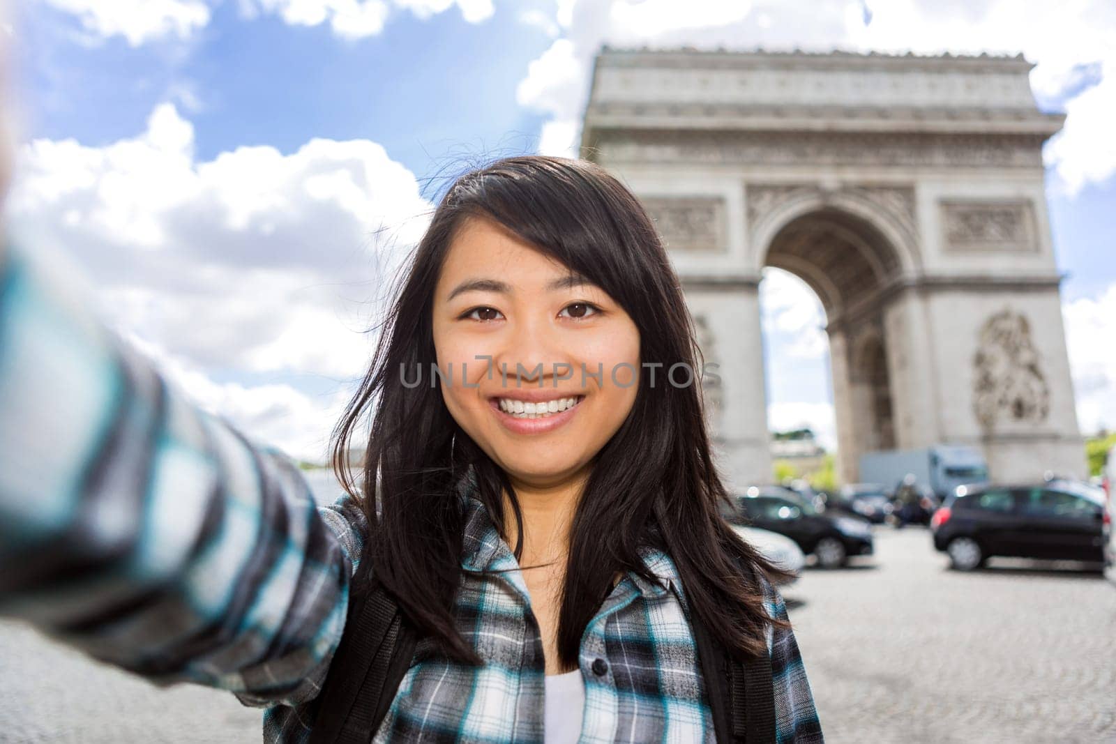 View of a Young attractive asian tourist in Paris taking selfie
