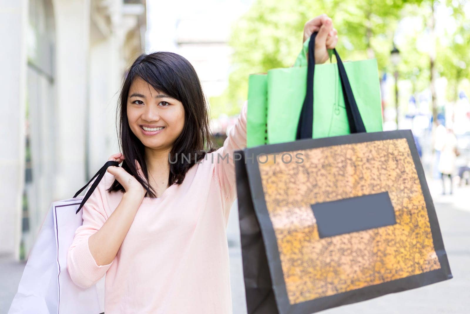 View of a Young attractive asian tourist doing shopping in Paris