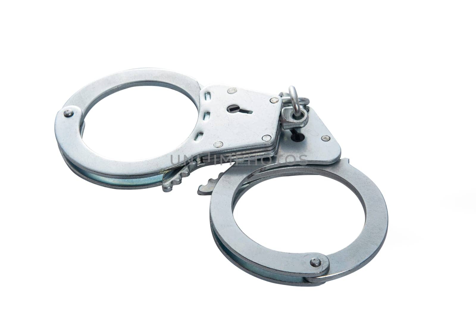 Metal handcuffs on a white isolated background, copy space. High quality photo