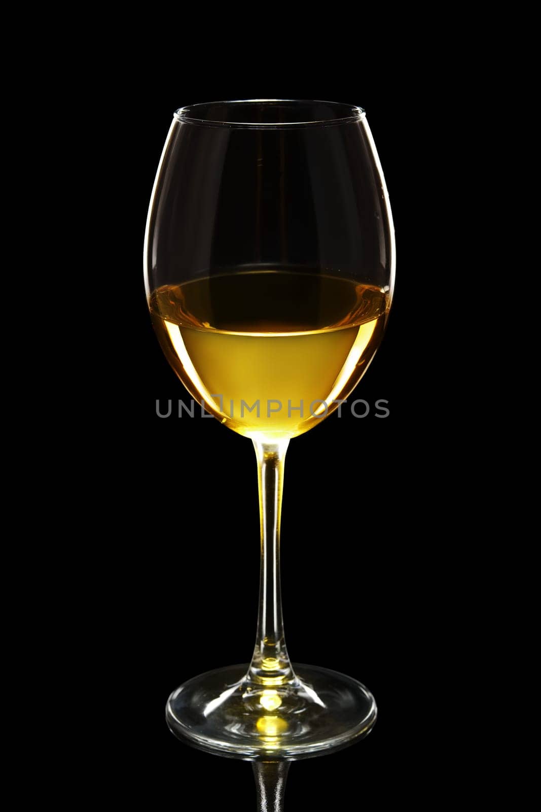 Glass of white wine isolated on black