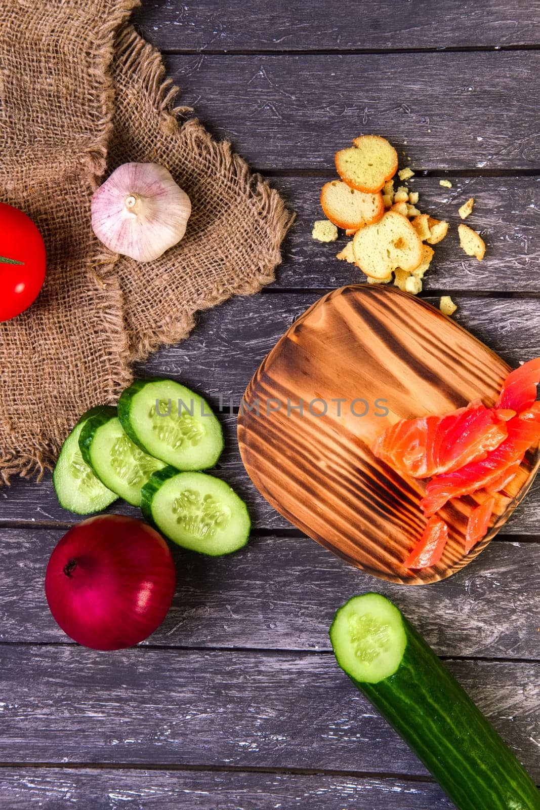 Fresh vegetables on wooden board with a napkin on a table.