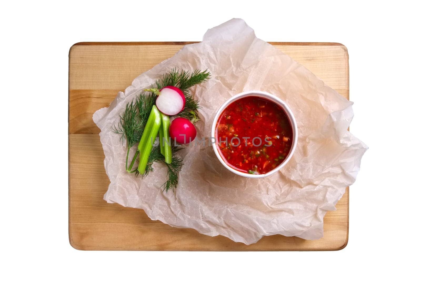 Top view of plate with celery and radish soup isolated on white