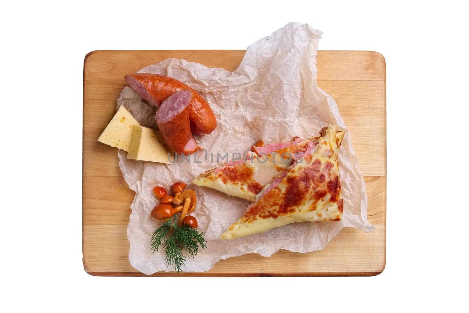 Thin pancakes stuffed with sausage, honey mushrooms and cheese isolated on white