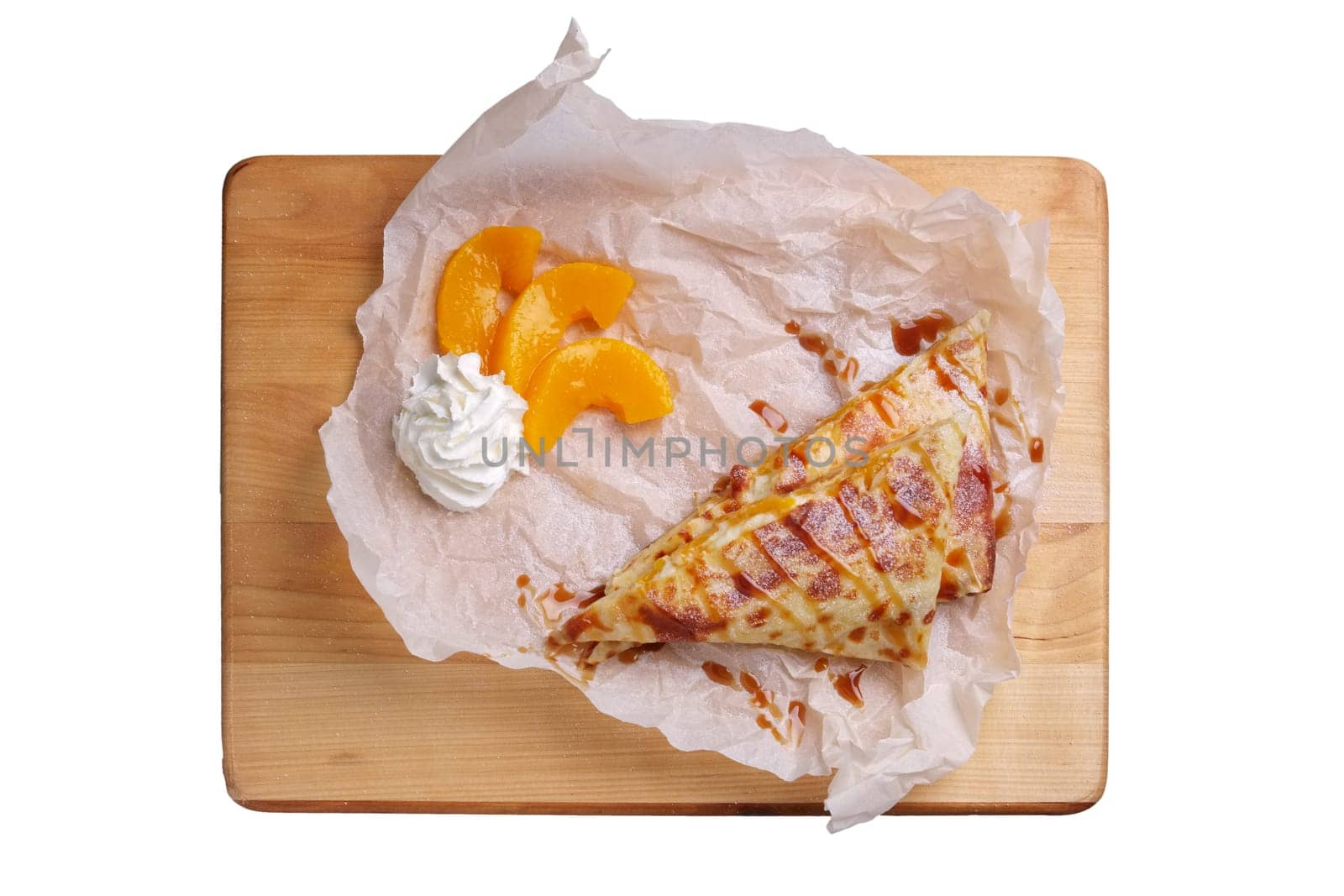 Thin pancakes stuffed with apricot and soft cheese isolated on white