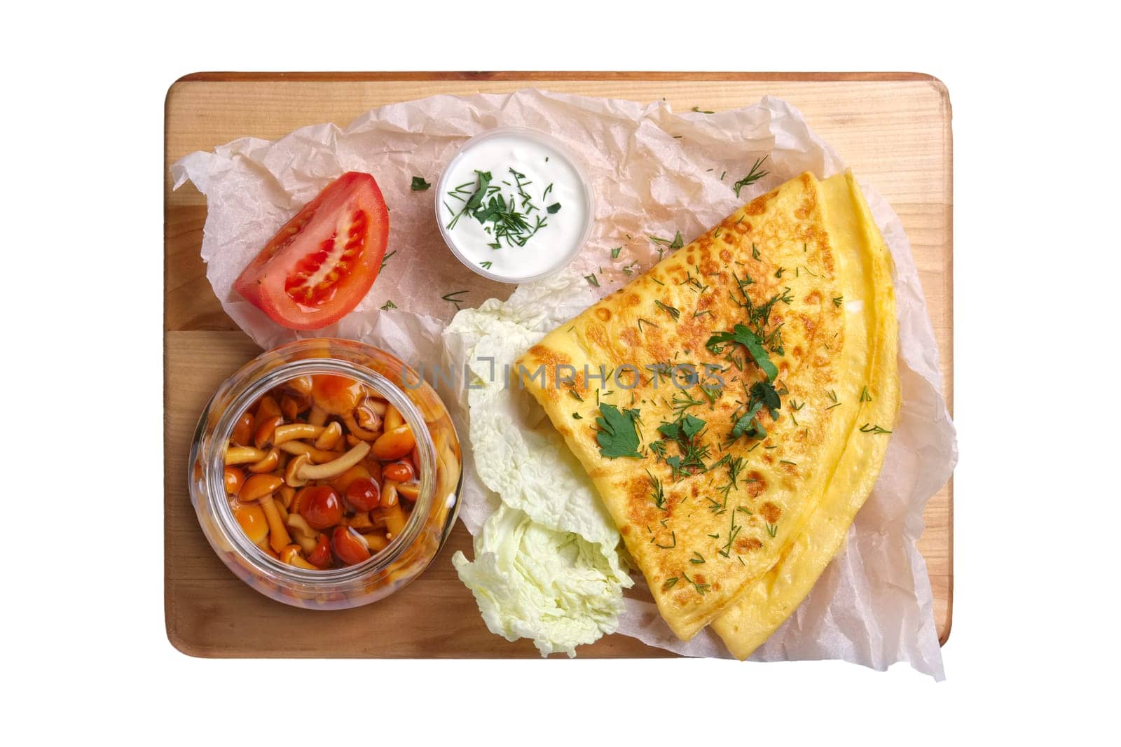 Top view of thin pancakes with honey mushrooms and tomato isolated on white background