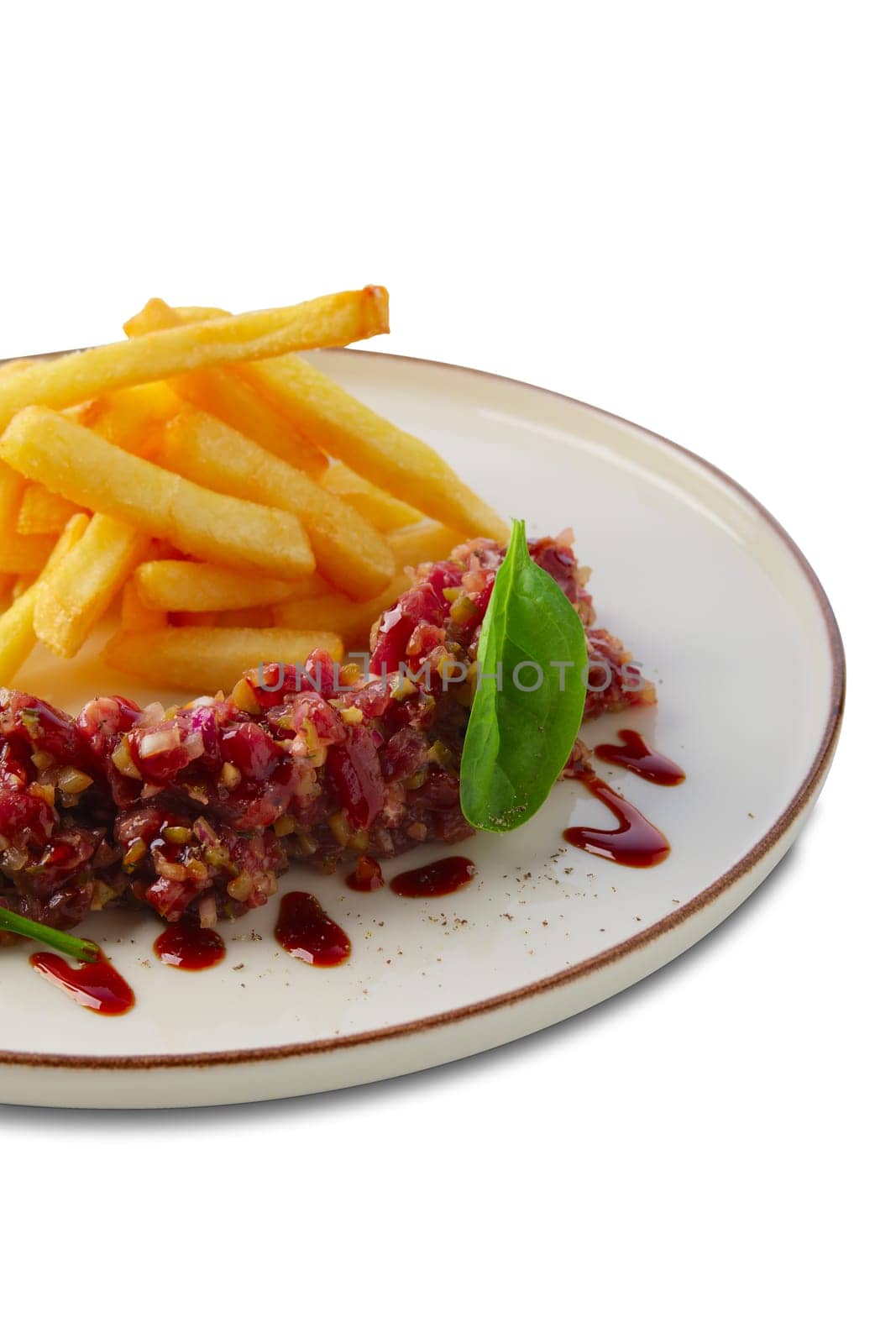 Beef tar tar  with balsamic sauce, basil and french fries isolated on white
