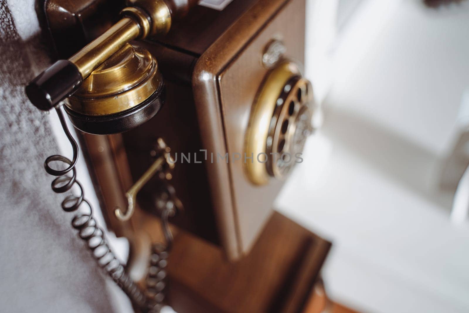 top view closeup of vintage brown wooden phone on wall