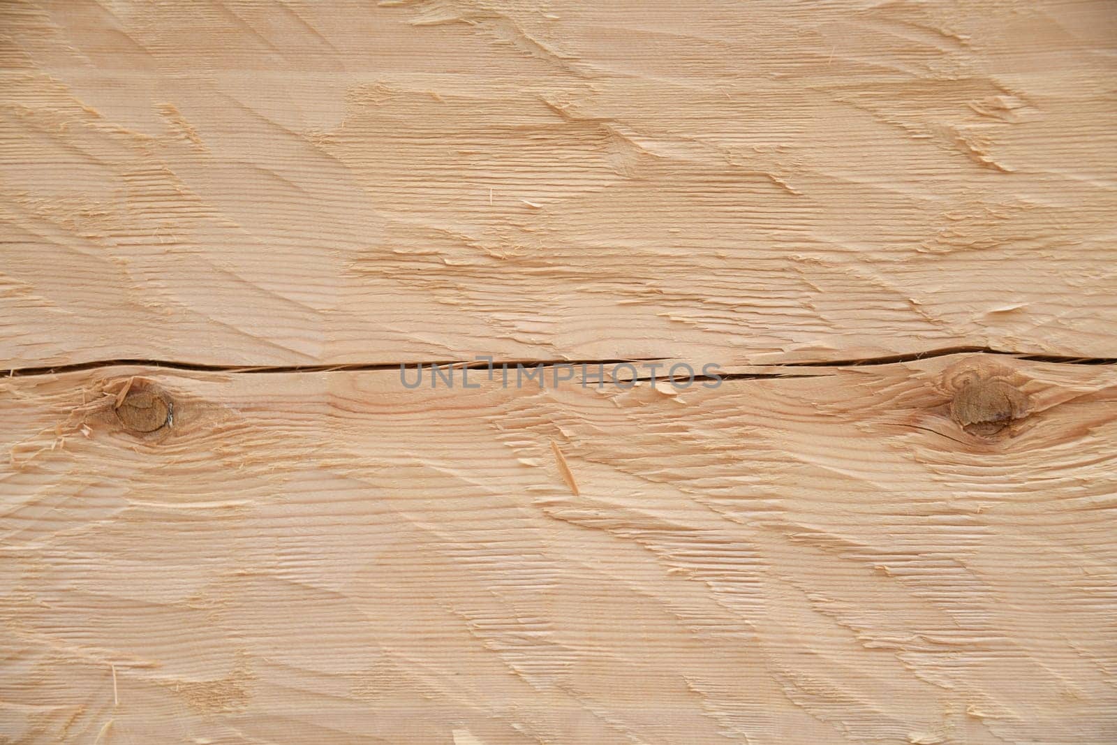 Close-up of the beveled pine wood in the raw state as a background. The pine is a softwood. The wood is coated with linseed oil balsam turpentine and thus made more durable.