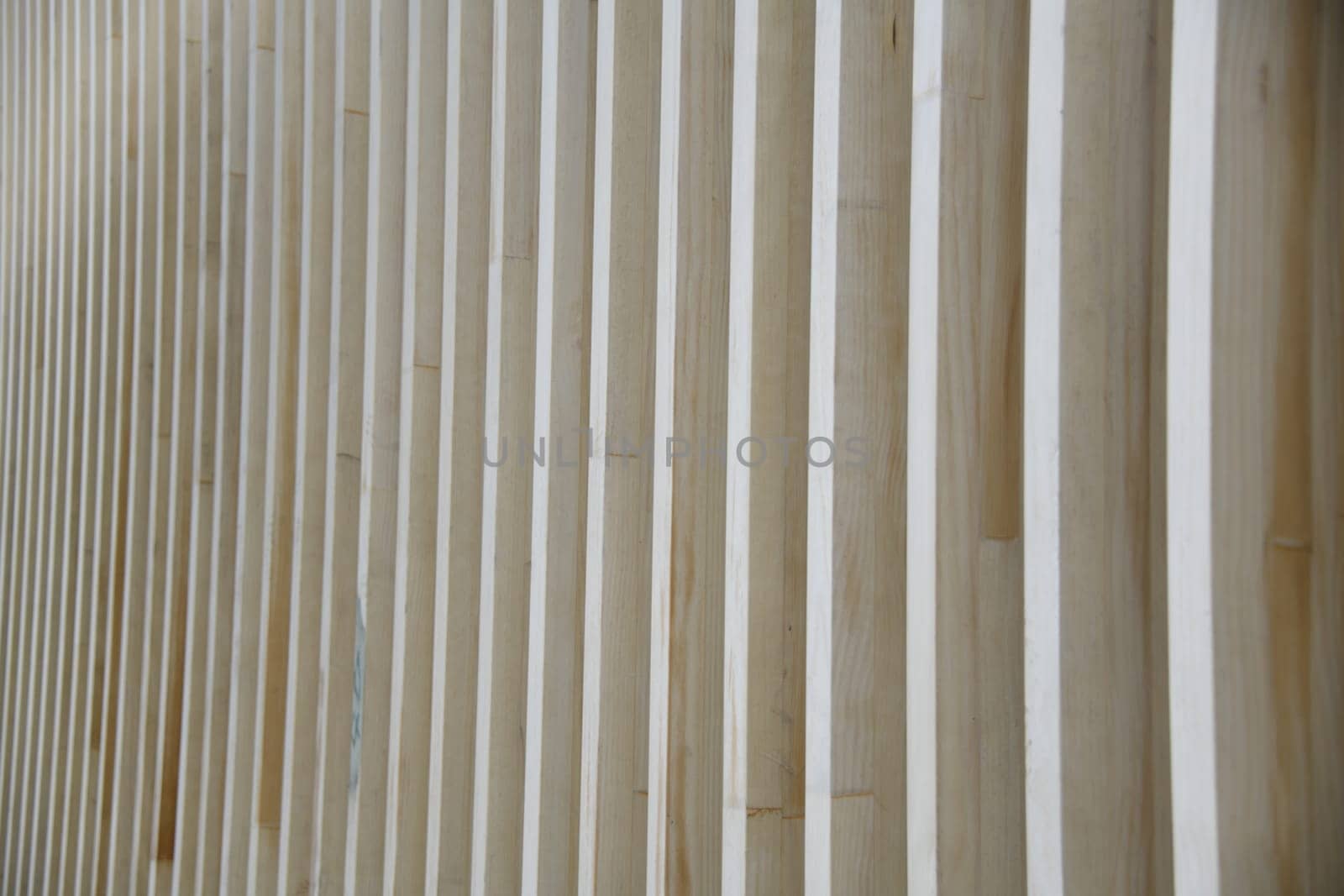 A wooden structure with waves and deformations as a background. Wood is a renewable raw material.