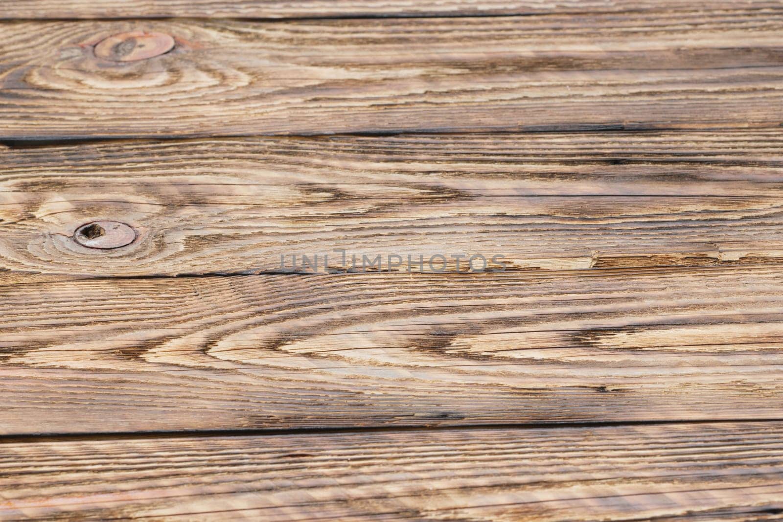 Soft focus photo of old partly burned wooden background
