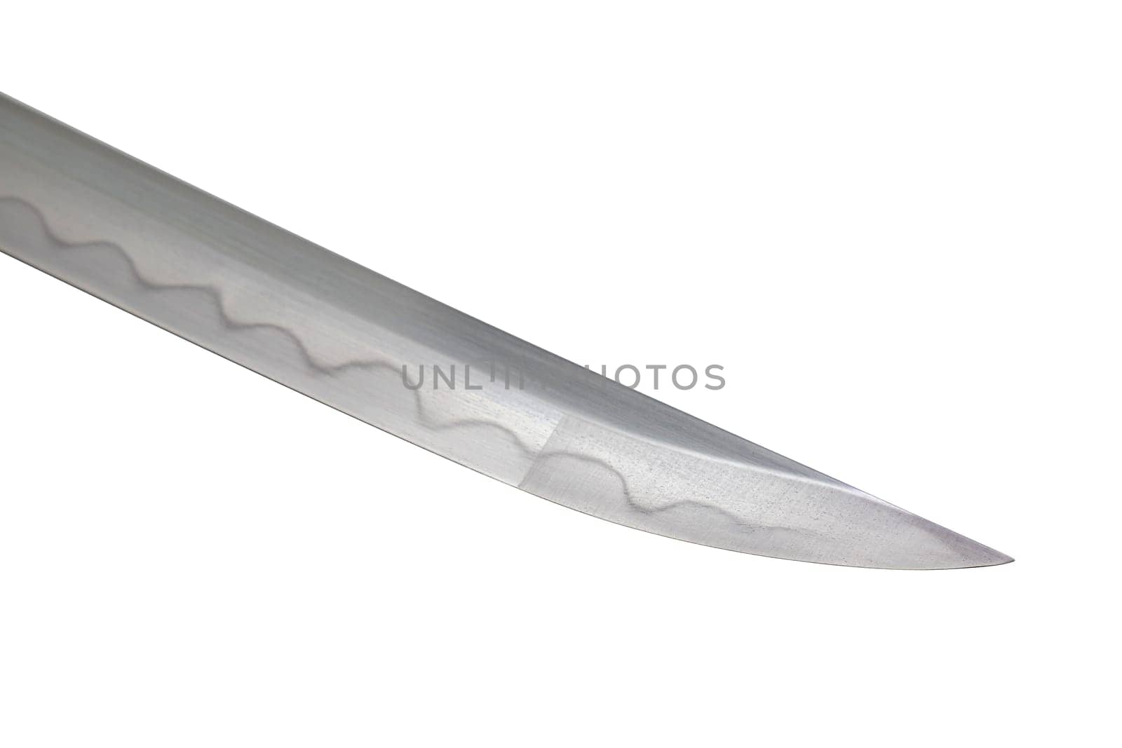 Japanese sword blade on white background. Soft focus. The wavy pattern on the blade edge is a line of hardness that a blacksmith makes so that the blade doesn't break. Each piece is unique.