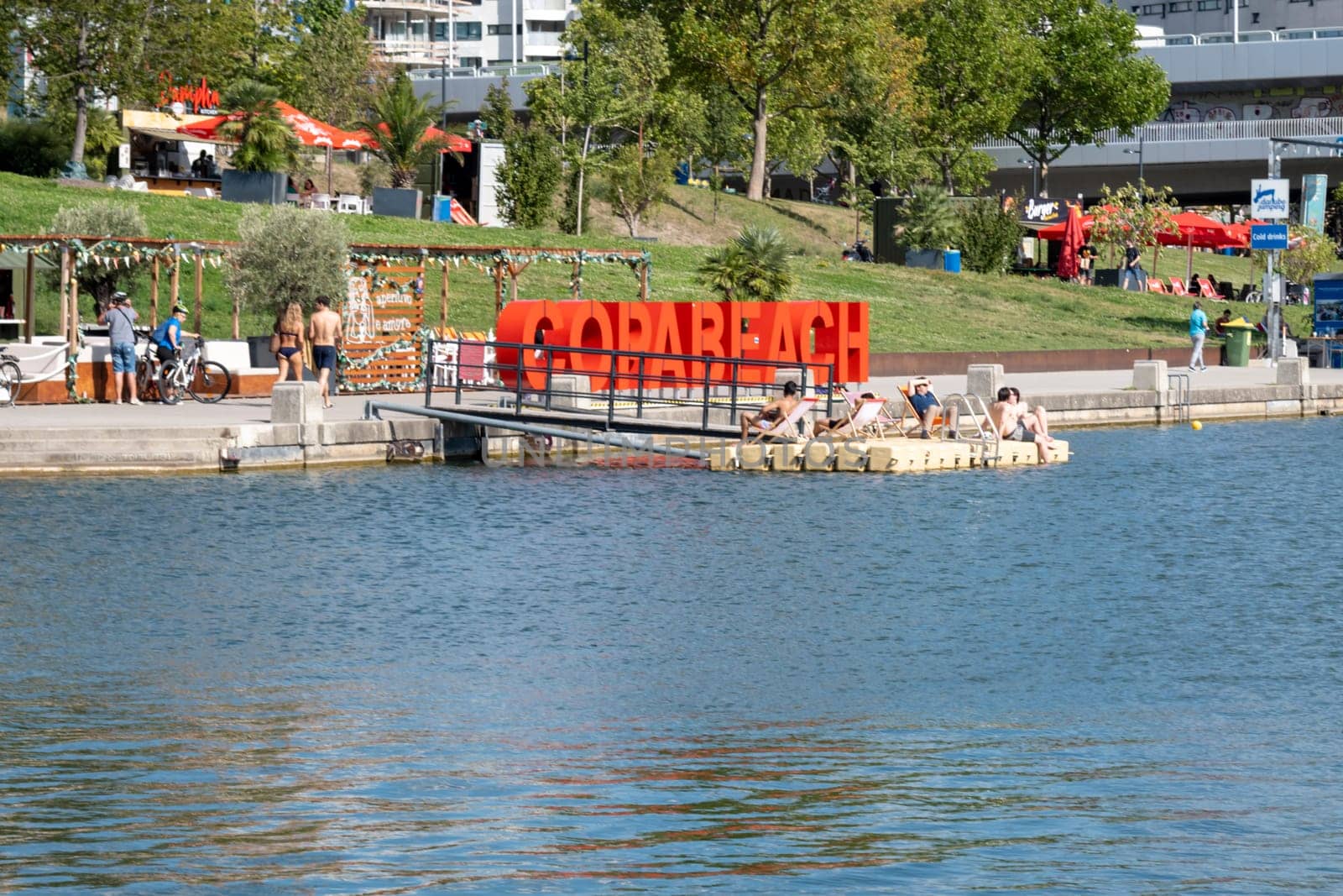 Vienna, Austria - August 10, 2022: The Viennese use them to relax, in bars and restaurants along the Old Danube or at Copa Beach and Sunken City on Danube Island.