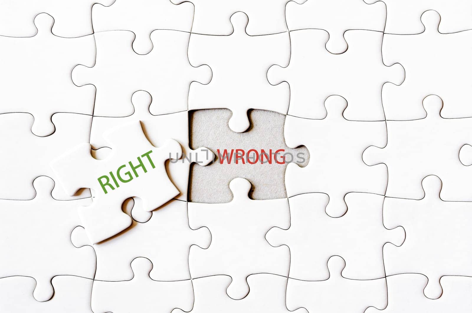 Missing jigsaw puzzle piece with word RIGHT, covering text WRONG. Business concept image for completing the final puzzle piece.