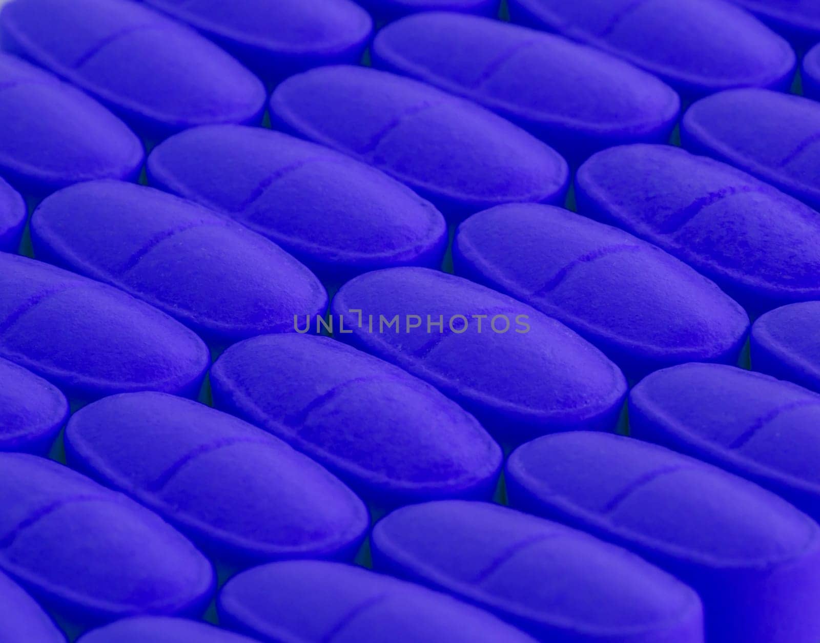 bunch of blue pills spilled on the table