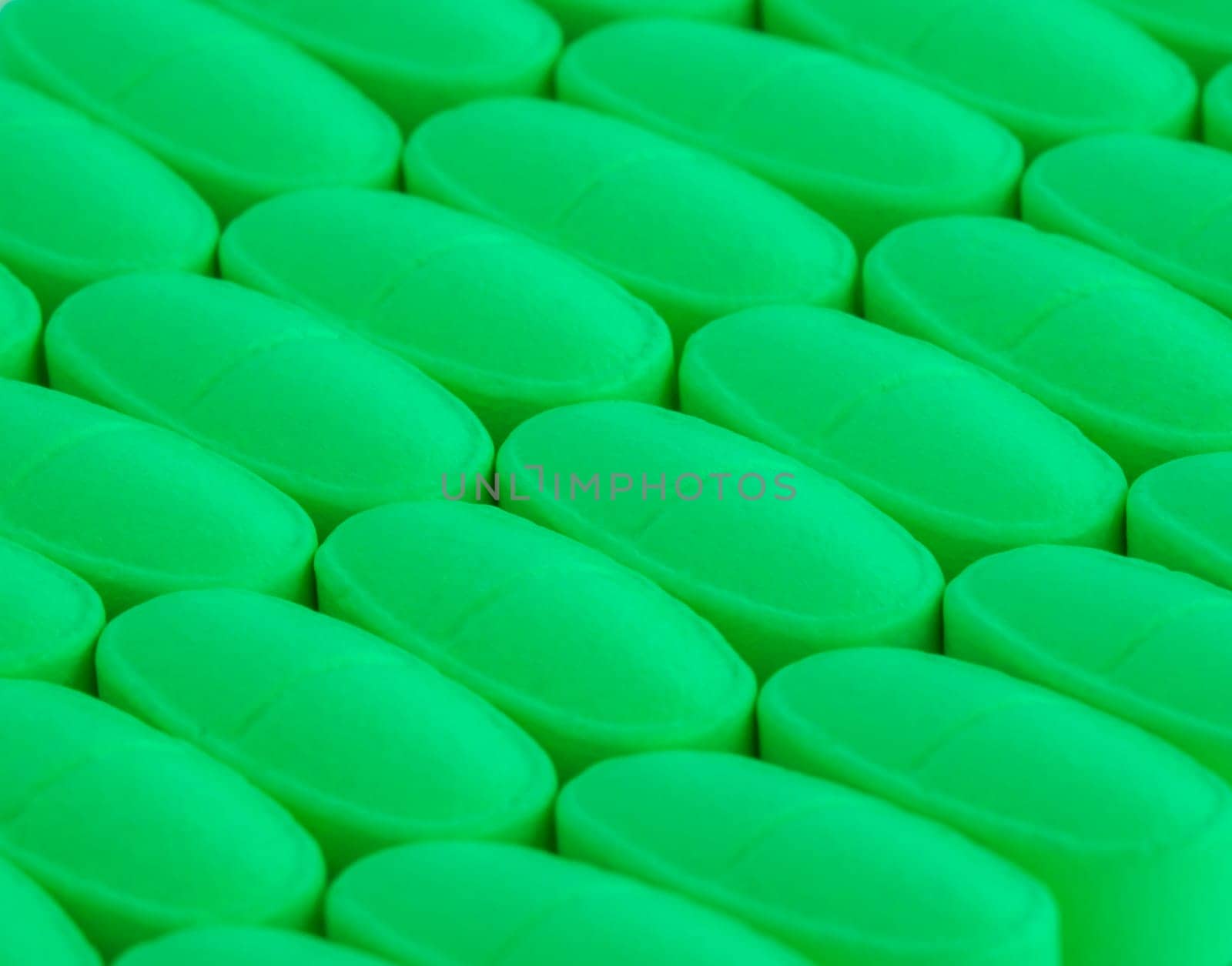 bunch of green pills spilled on the table