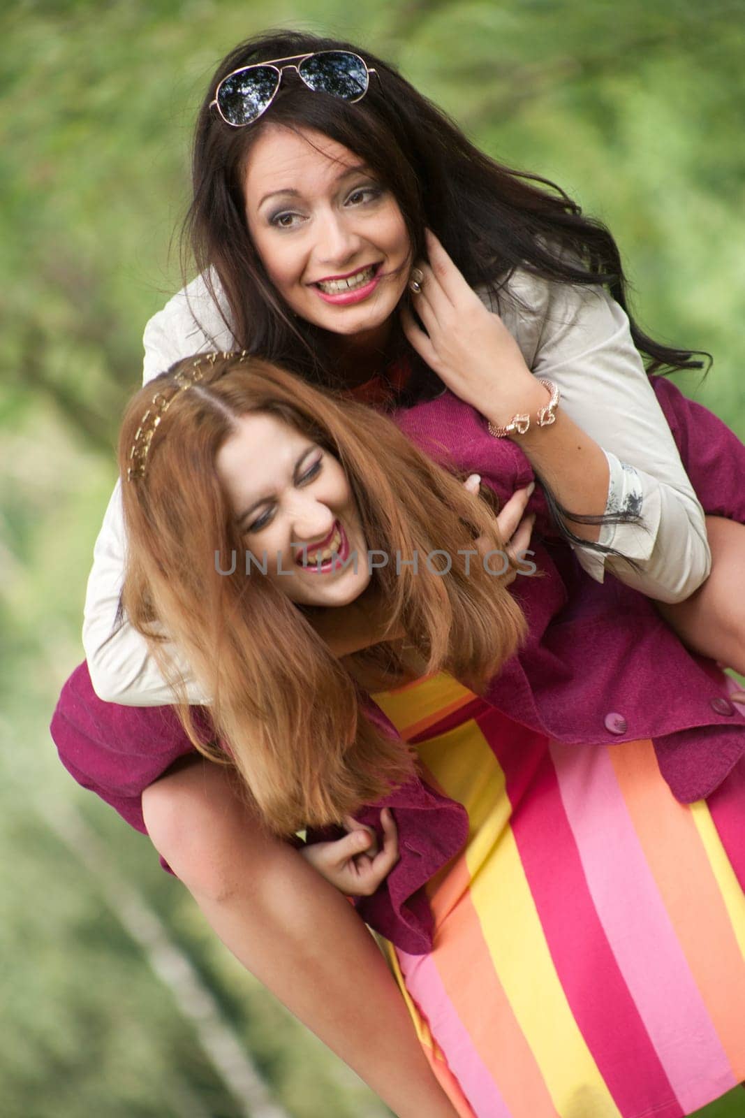 Two girls are having a lot of fun in the forest