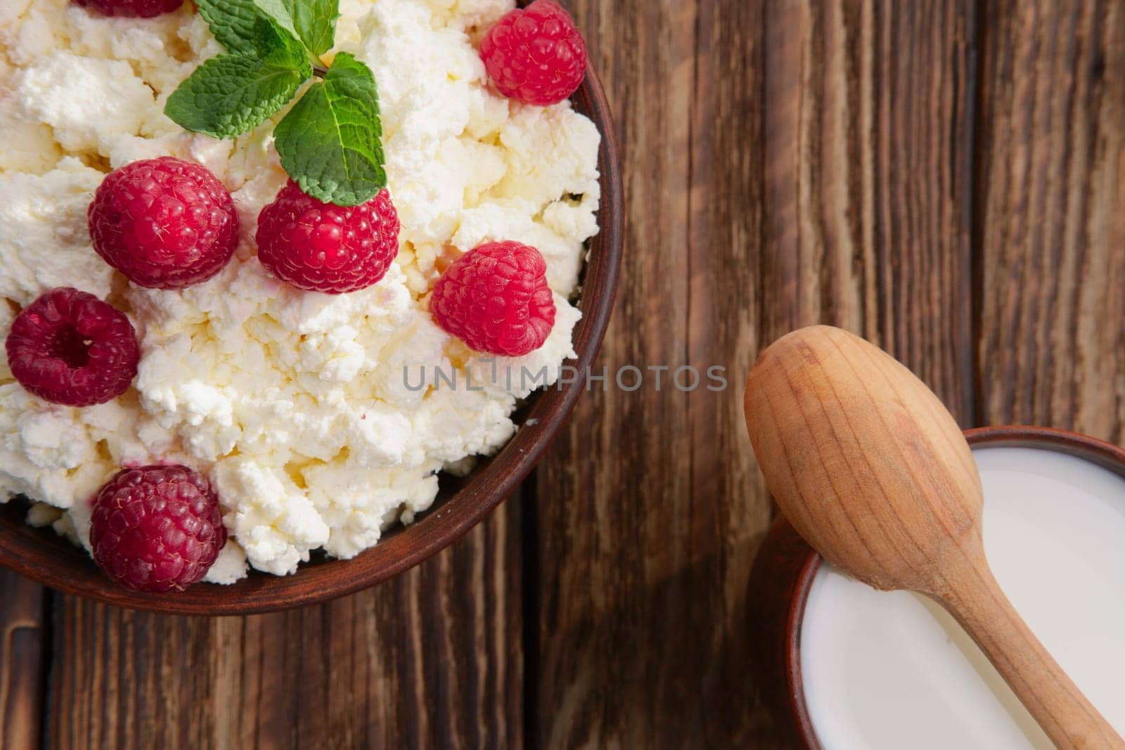 Dairy products: milk, cottage cheese, raspberry and mint. Copy space background
