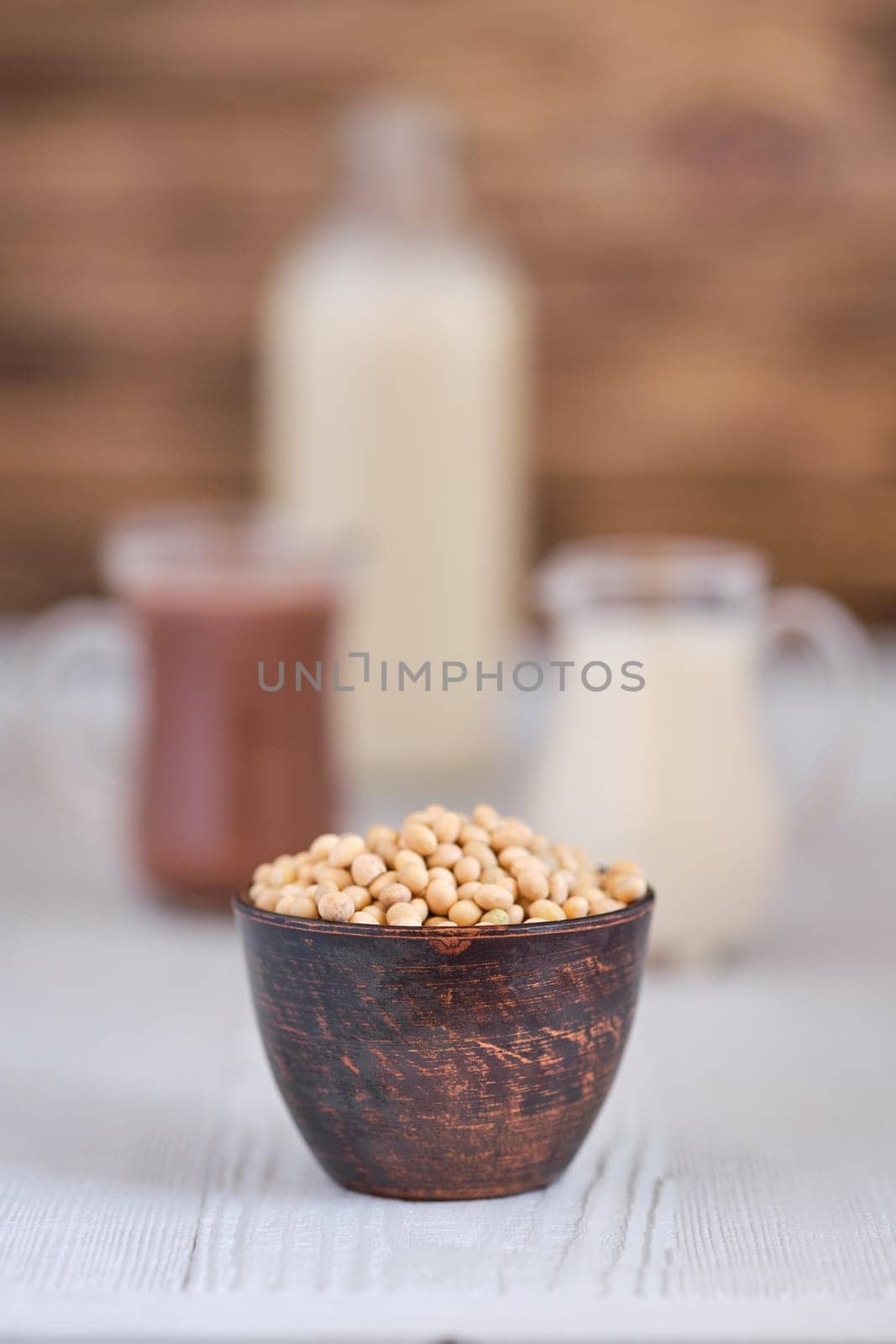 Chocolate milk and soy milk on white wooden table (photo with shallow depth of field)