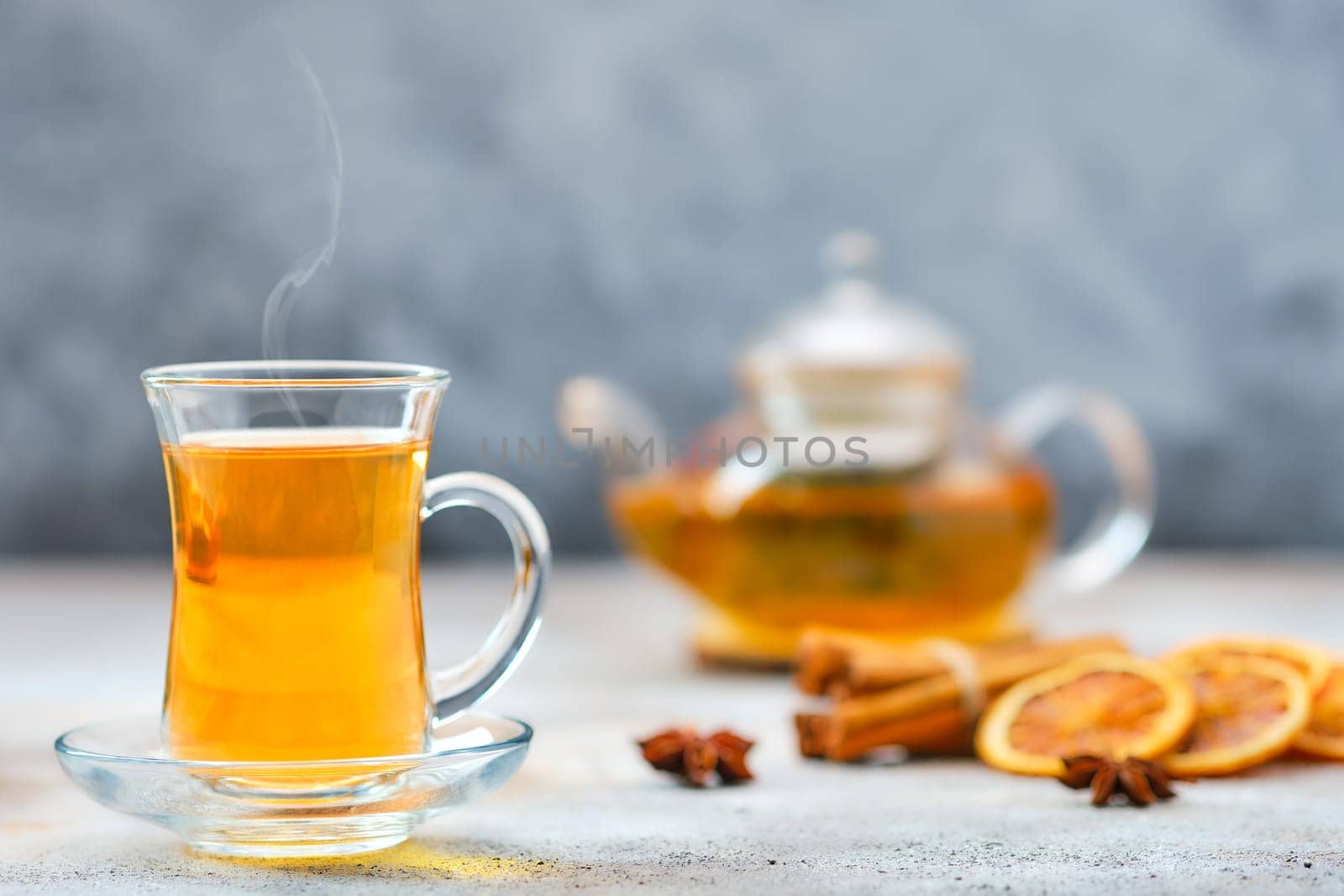 Hot citrus tea with cinnamon and anise (soft focus photo with shallow depth of field)