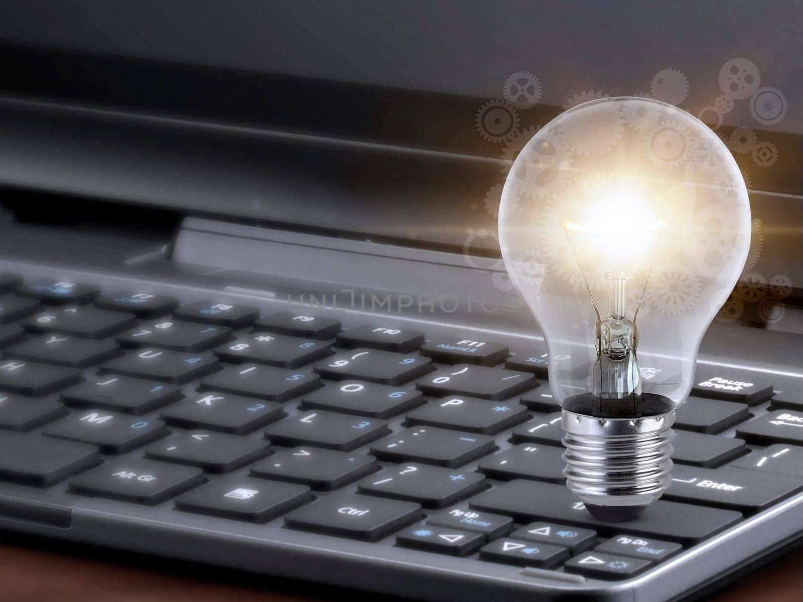 Laptop and glowing light bulb. Self learning or education knowledge and business studying concept. Idea of learning online or e-learning from home
