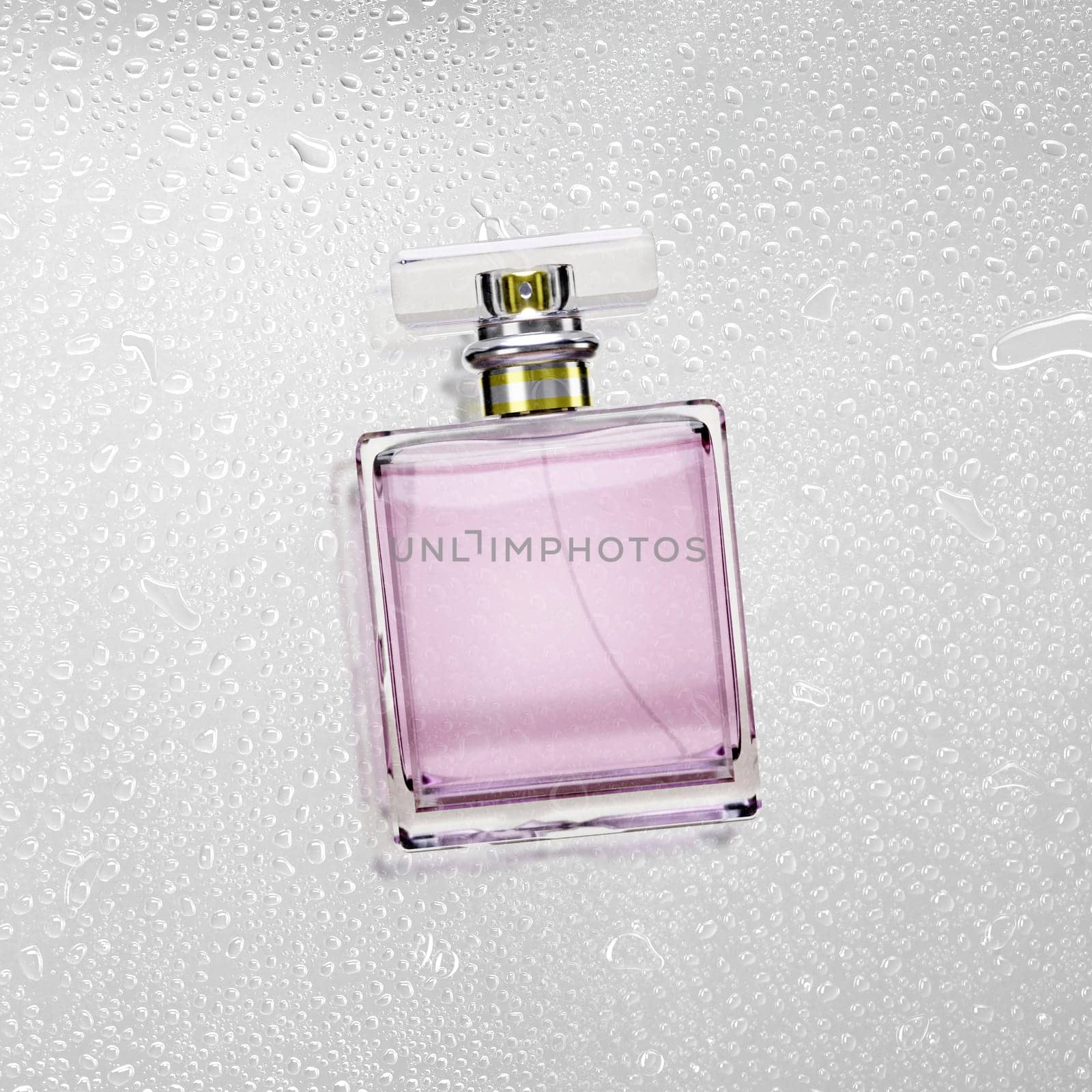 Perfume bottle on water drops background texture