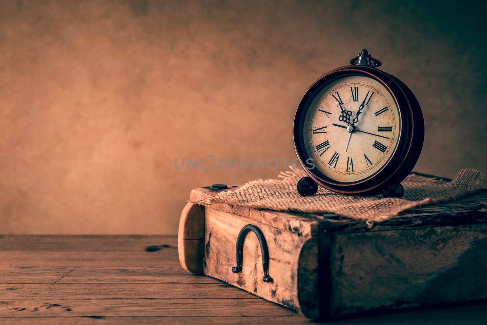 Vintage alarm clock with copy space. Photo in retro color image style