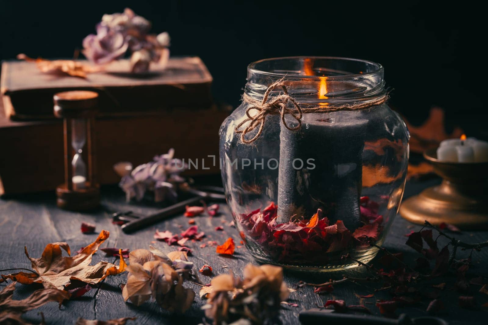 Fall candle decoration with dried leaves, autumn wooden home decor still life scented candle, autumn season interior decoration details