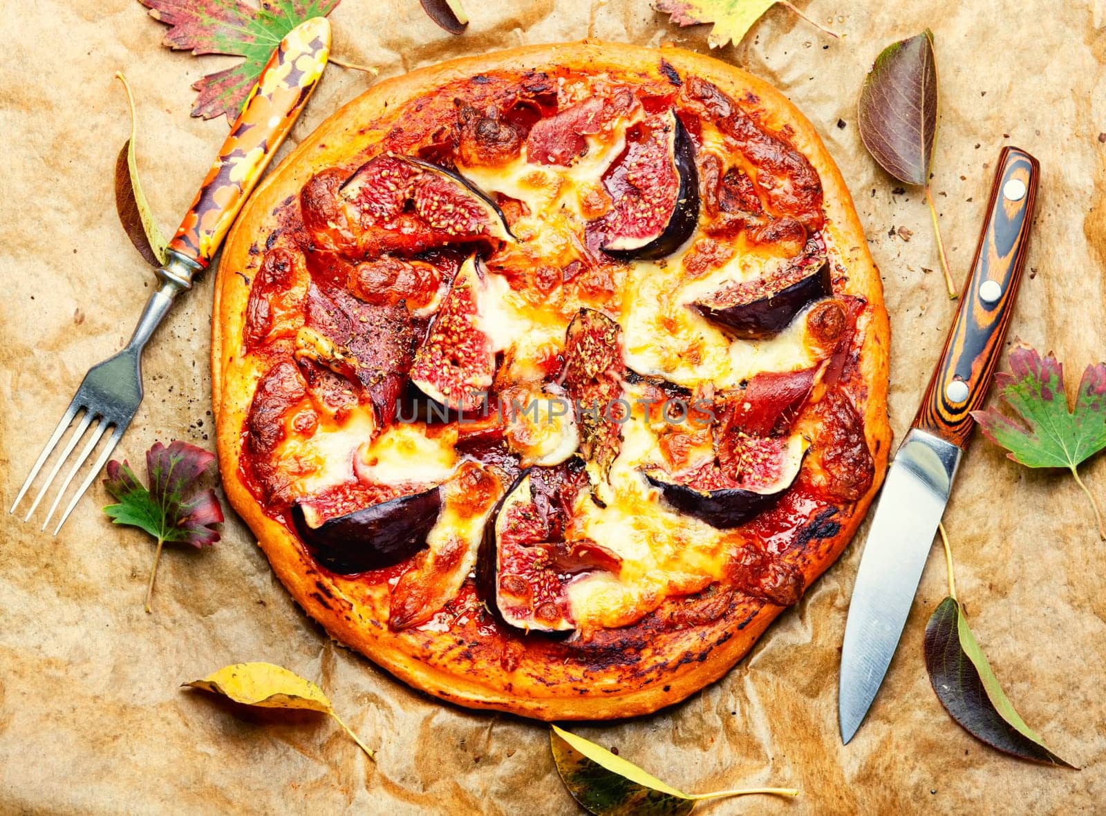 Pizza baked with meat and autumn figs