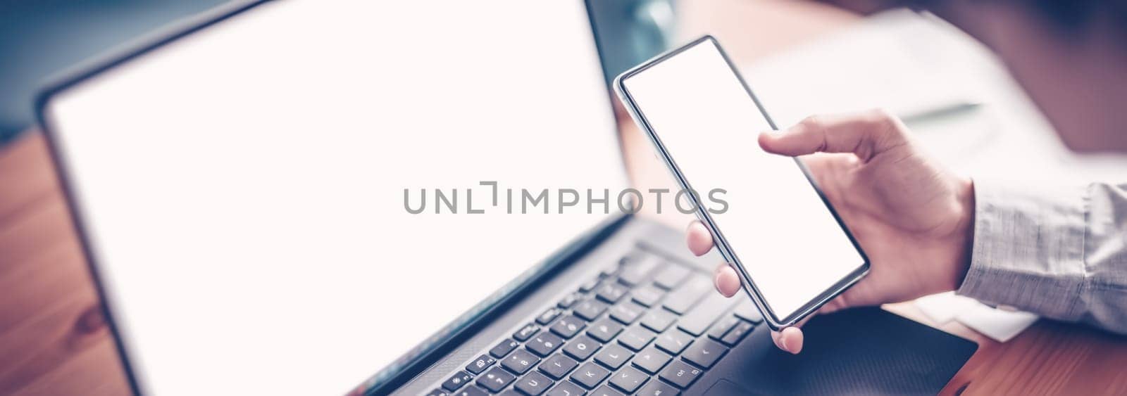 Businessman sitting at the table and using smartphone. Concept business management and coworking in businessteam.