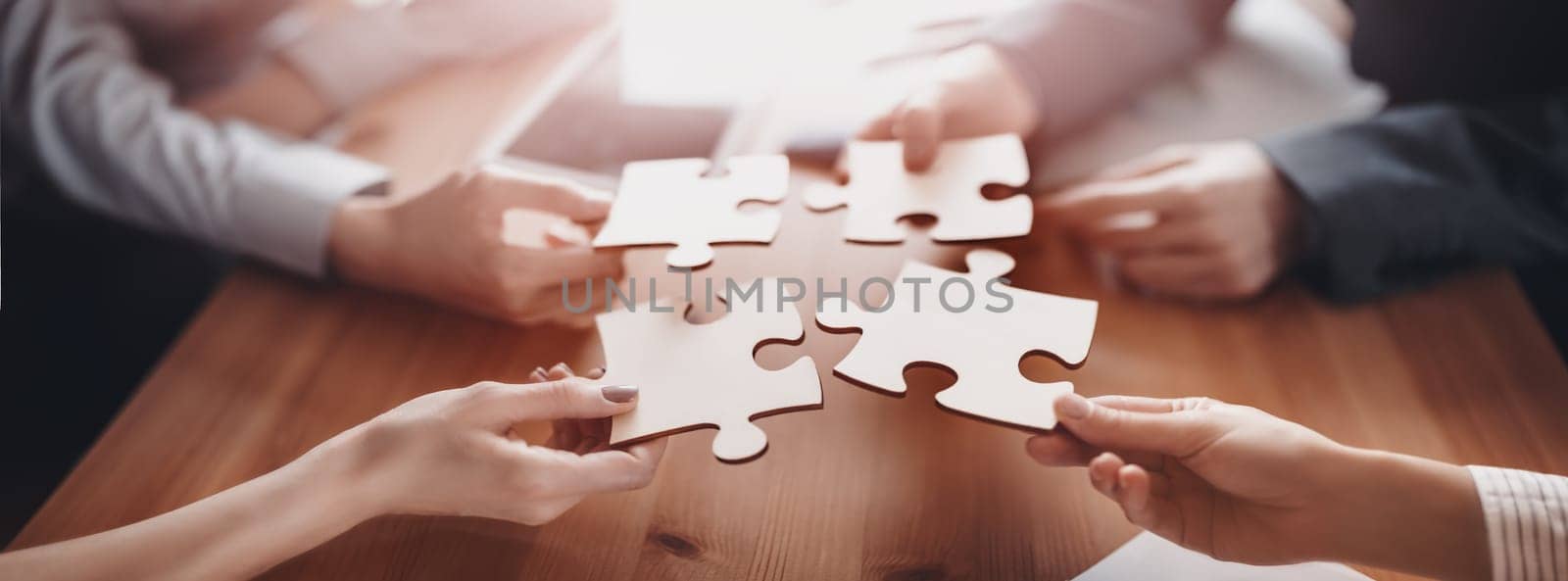 Buisnesswomen and buisnessmen working together while putting together puzzles. Concept of teamwork and cooperation in business