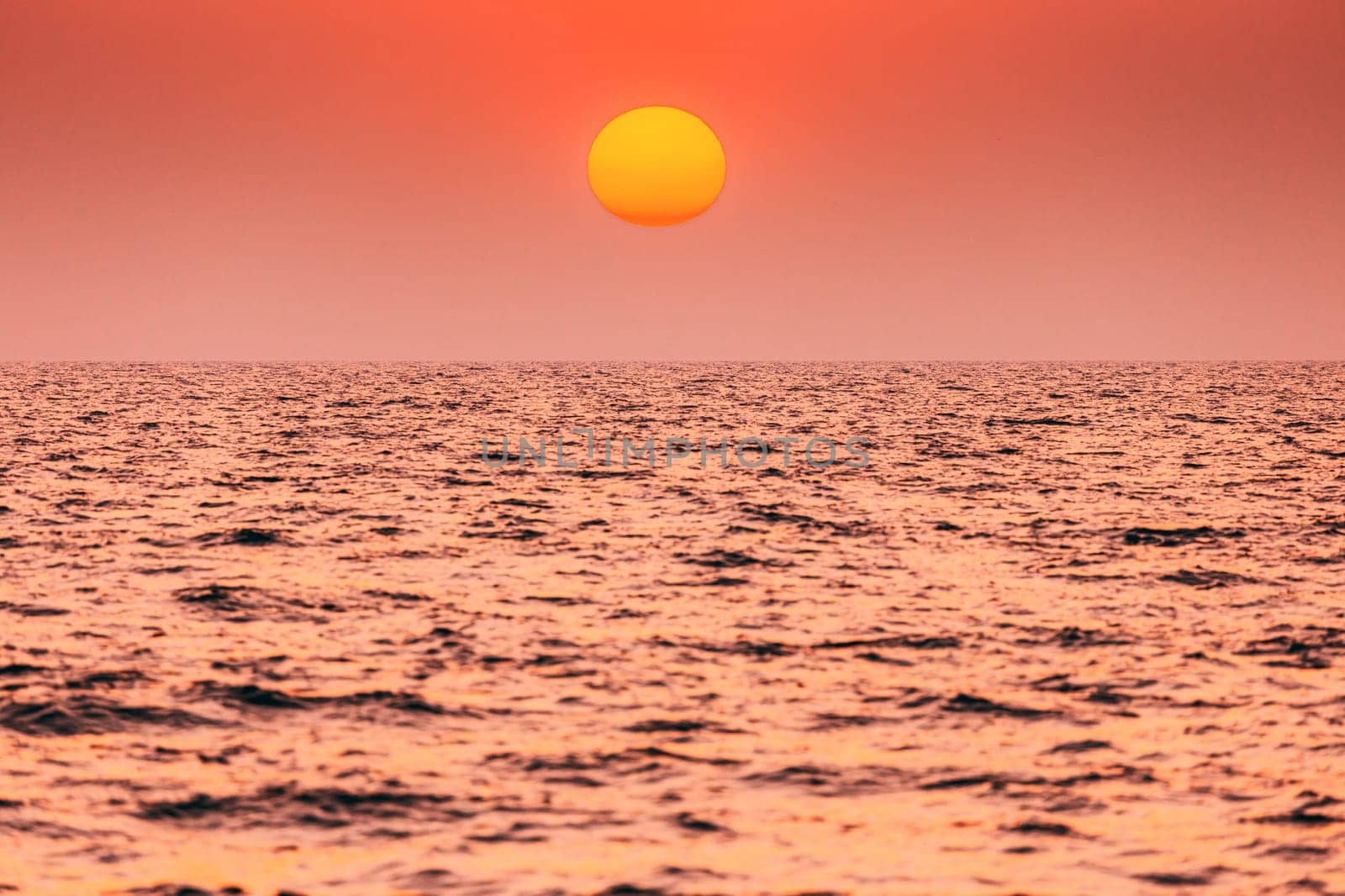 Natural Color Sunset Sunrise Sky Over Sea. Seascape With Shining Setting Sun On Sea Horizon.