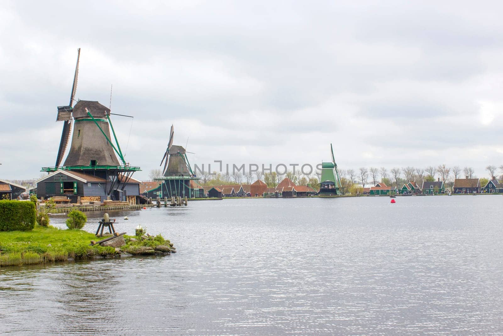 rural landscape with windmills at famous tourist site Zaanse Schans in the Netherlands