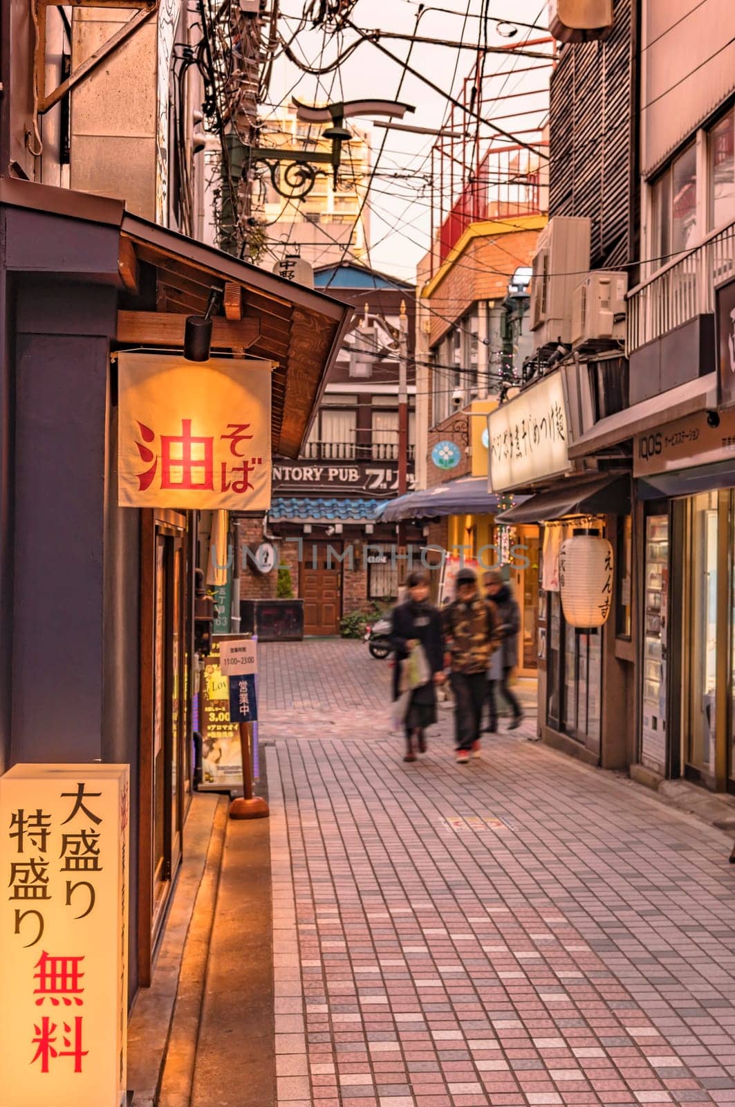 tokyo, nakano - dec 25 2020: Backstreet of Nakano Station Where is Japanese Soba noddles restaurants with illuminated signes where is inscribed free heaping.
