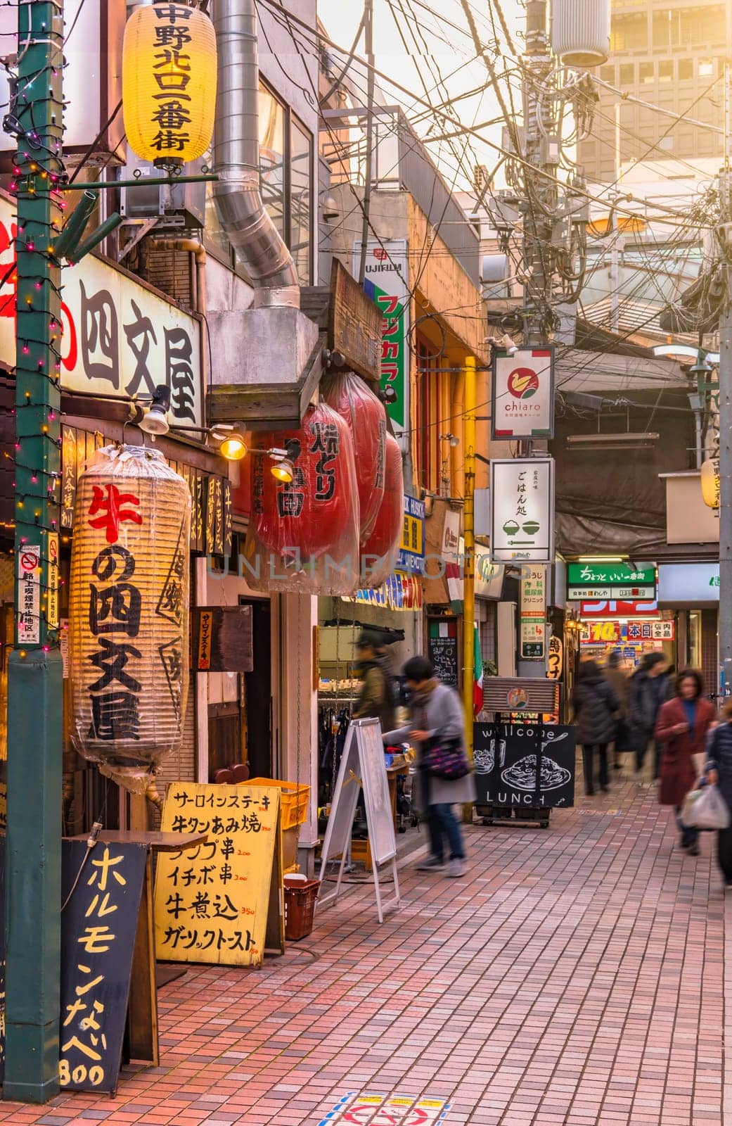 tokyo, nakano - dec 25 2020:Backstreet of Nakano Station North gate where is a lot of illuminated paper lanterns at the entrance of restaurants.